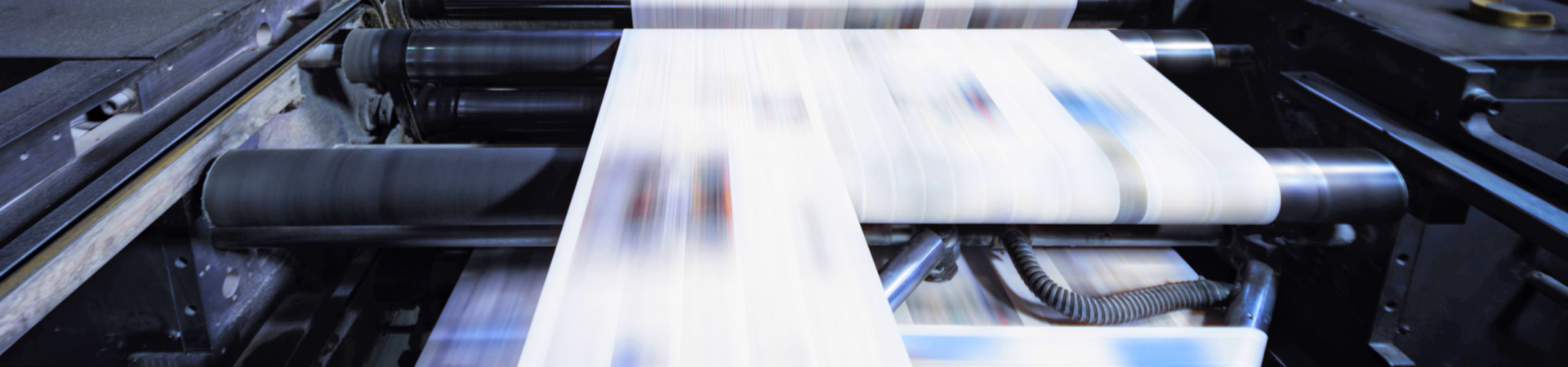  a printing press with pages running through quickly 